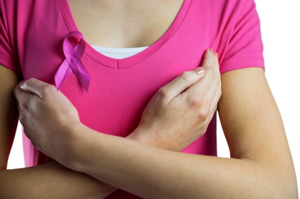 Woman with breast cancer ribbon on white background